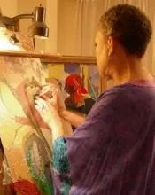 A woman painting in an art studio.